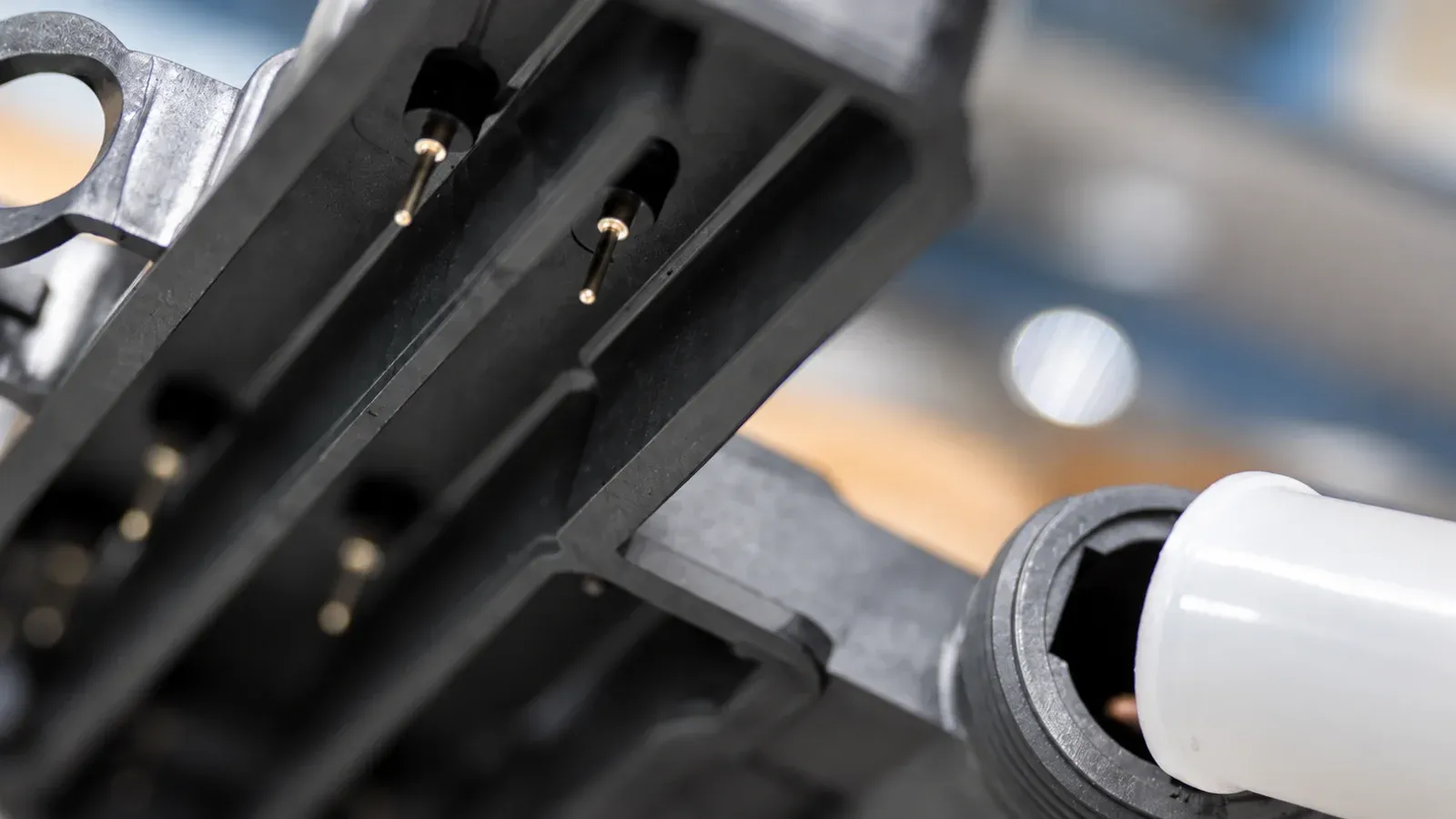 Close-up of metal inserts positioned in an injection molded plastic component