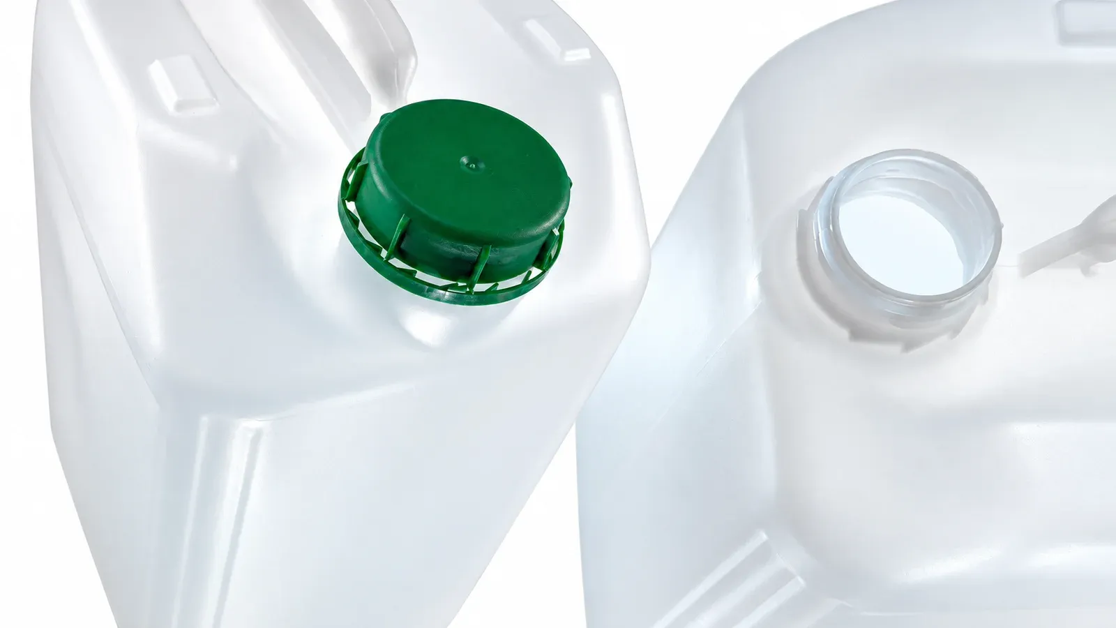 Close-up of white WERIT HDPE jerrycans showing a green screw cap and an open neck